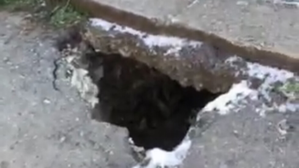 Метър и половина дупка в тротоара